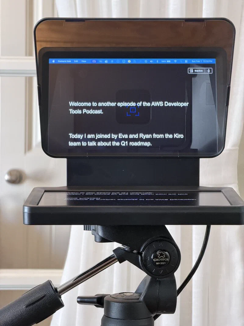 The Elgato Prompter displaying a script. The text is clearly visible on the reflective glass while the camera behind captures video without any obstruction.